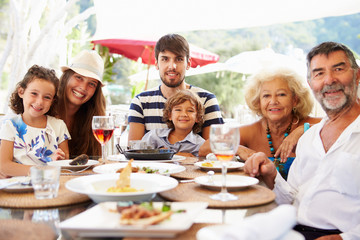 Multi Generation Family Enjoying Meal In Restaurant