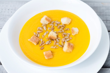 Pumpkin soup against wooden background