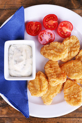 Chicken nuggets with sauce on table close-up