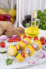 Sliced vegetables on picks on board on table close-up