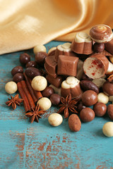 Different kinds of chocolates on wooden table close-up