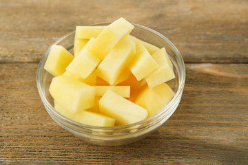 Raw peeled and chopped potatoes in glass bowl