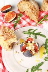 Ripe sweet fig with cottage cheese and honey, on plate