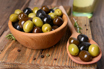 Different marinated olives on table close-up