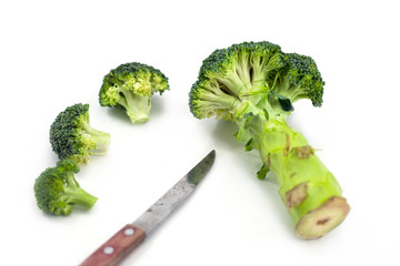 chopping broccoli with knife isolated on white background