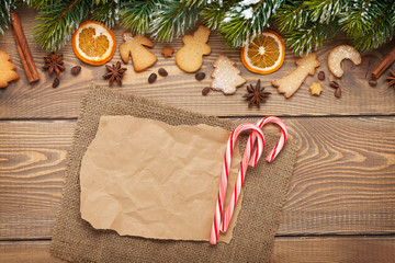 Christmas background with snow fir tree, spices, gingerbread coo