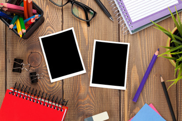 Office table with notepad, colorful pencils, supplies and photo