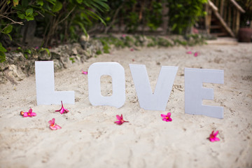Word love on sandy beach at beautiful resort