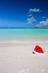 Merry Christmas written on tropical beach white sand with xmas