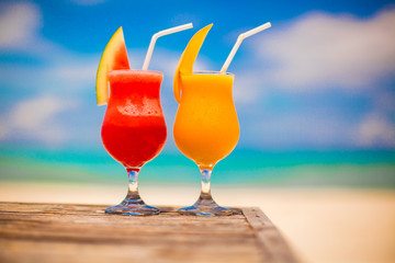 Two cocktails fresh watermelon and mango on background of