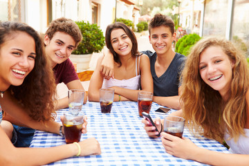 Group Of Teenage Friends Sitting Together At Caf‚