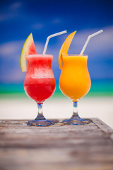 Two cocktails fresh watermelon and mango on background of