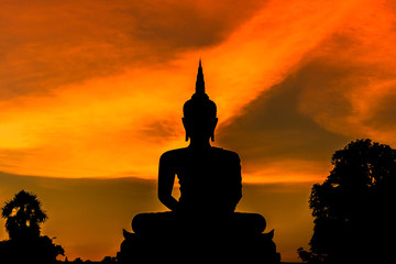silhouette big buddha statue sitting on sunset