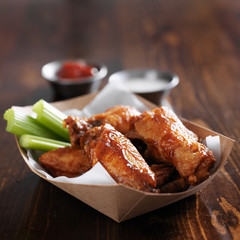 barbecue buffalo chicken wings with celery sticks