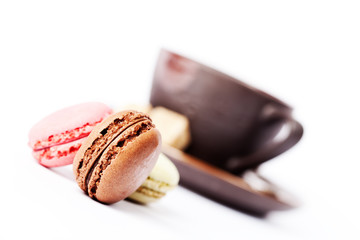 Cup of coffee and macaroons on white background, toned