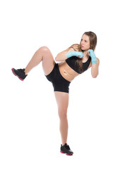 Fototapeta premium Young woman posing and kicking