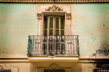 Old building elevation - vintage balcony, shutters and ornaments