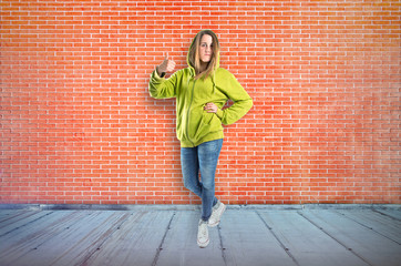 Girl with thumb up over textured background