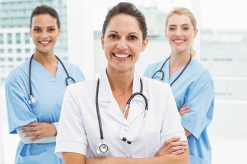 Portrait of confident female doctors with arms crossed