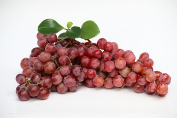 Fototapeta premium Red grapes with fresh leaves, isolated on white background