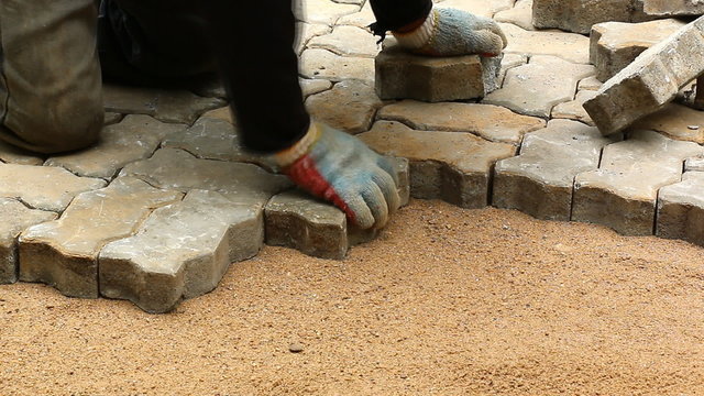 worker installing old cobblestone block (time lapse)