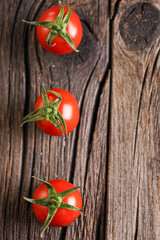 Fresh organic tomatoes on wooden table