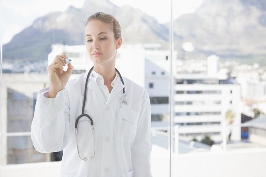 Doctor Writing On A Clear Board