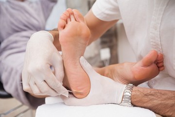 Salon worker using a scalpel