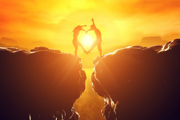 Happy couple in love making heart shape over precipice - Powered by Adobe