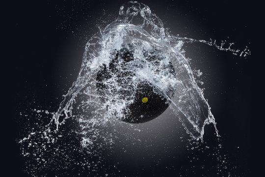 Sport ball with water splash on black background