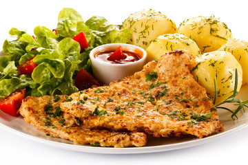 Fried pork chop, boiled potatoes and vegetable salad