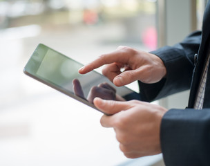 Man hand touching screen on modern digital tablet pc