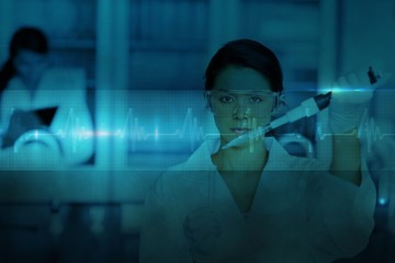 Serious chemist working with large pipette