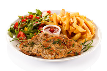 Pork chop, French fries and vegetables
