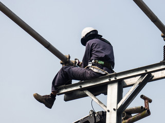 Workers setting up an electric sub station