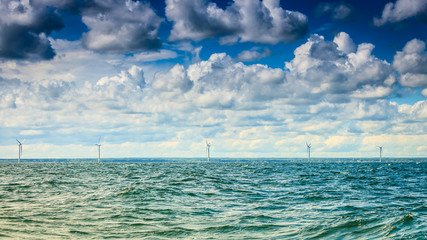 Fototapeta na wymiar wind turbines power generator farm along coast sea