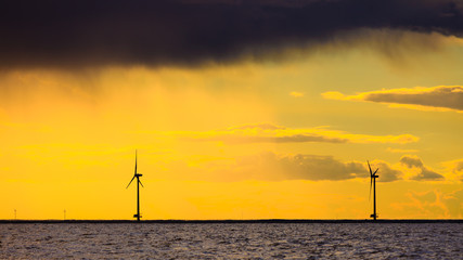 wind turbines power generator farm along coast sea