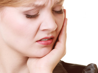 Toothache. Young woman suffering from tooth pain isolated