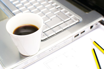 Computer and coffee in the office table