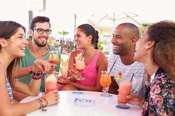 Group Of Friends Drinking Cocktails At Outdoor Bar