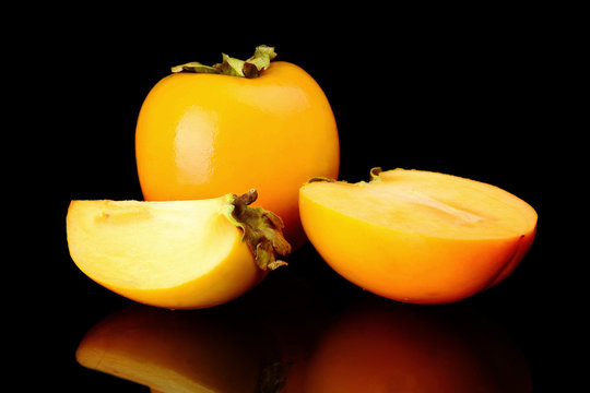 Studio shot many kakis sliced isolated black