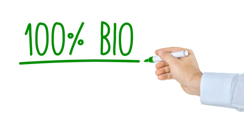 Hand mit Stift schreibt 100 Prozent Bio