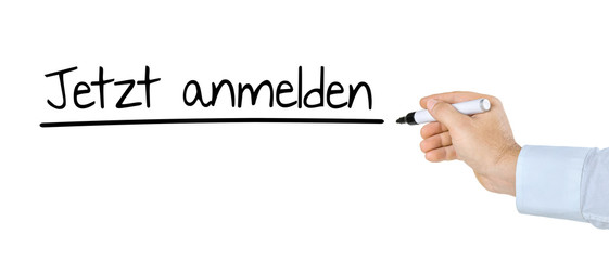 Hand mit Stift schreibt Jetzt anmelden