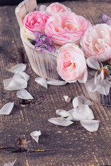 Roses on wooden background.