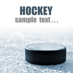 black hockey puck on ice rink