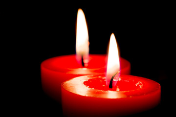 Closeup of burning candles on black background, christmas, holid