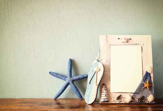 vintage nautical frame with starfish on wooden table. retro filt