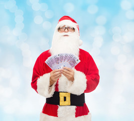 man in costume of santa claus with euro money