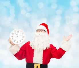 man in costume of santa claus with clock