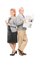 Mature couple with a newspaper and cup of coffee